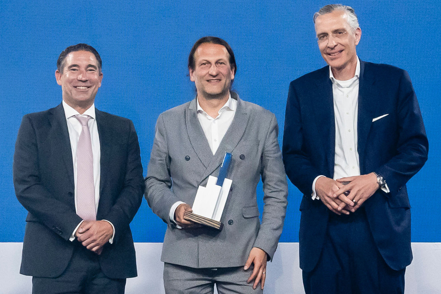 Dr. Andreas Billmeyer mit dem Award als bester Immobilieninvestor und den beiden Gratulanten, Marcus Kuntz von Universal Investment und Dr. Stephan Kloess von der Jury.